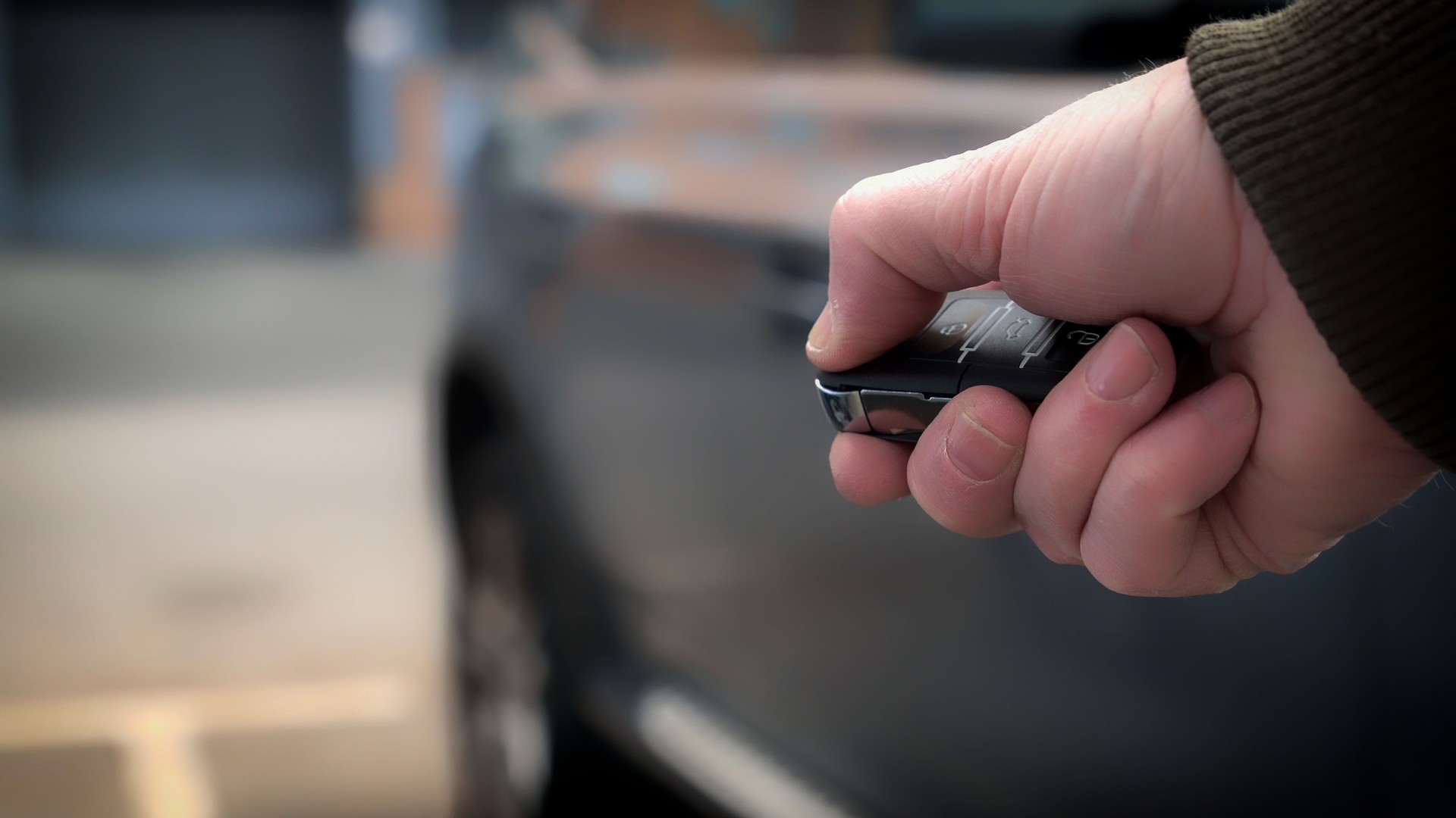 Man using remote control to open car